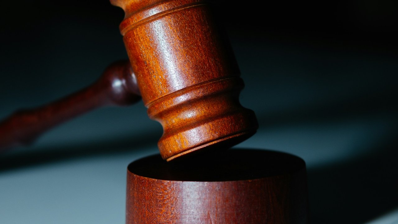 A wooden gavel on a white counter.