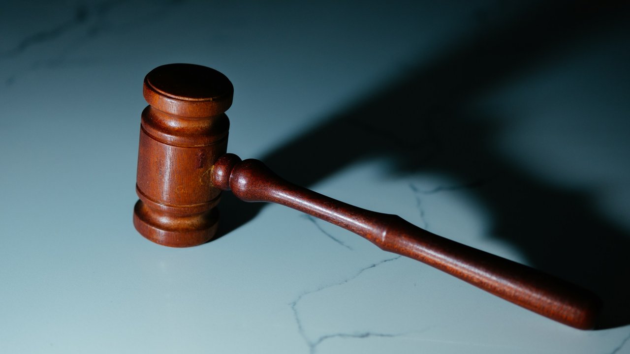 A wooden judge's gavel on a table.