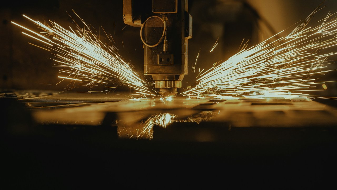 A machine cutting a piece of metal.
