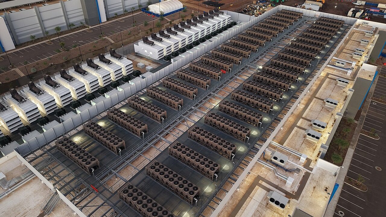 Aerial view of a data centre roof with rows of air-cooling units and rooftop plant equipment