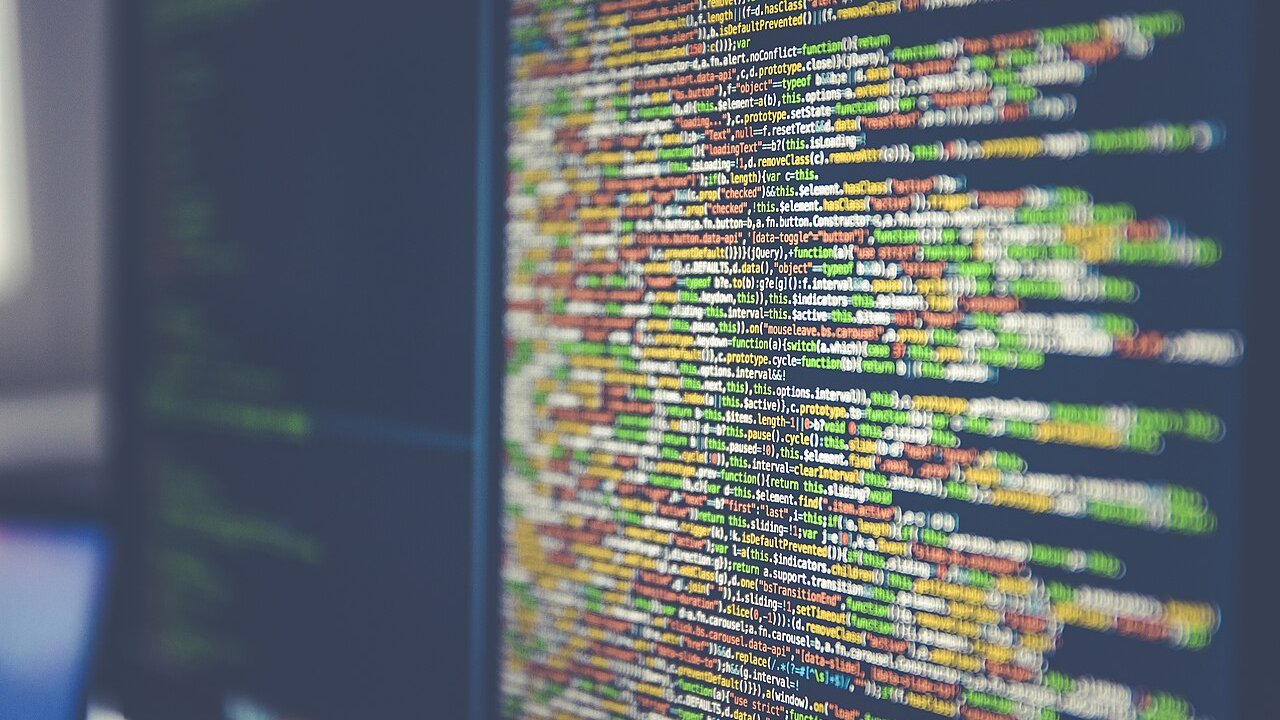 Lines of colourful source code displayed on a computer monitor