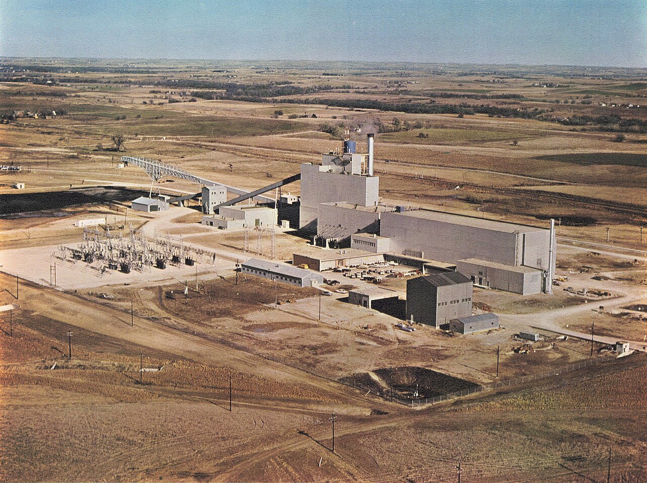 An aerial view of a power station and substation on open plains