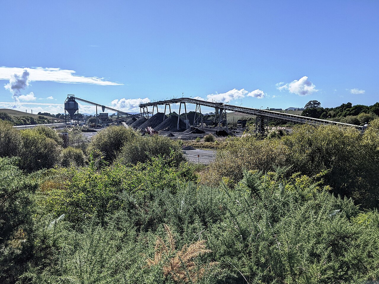 An open-cast coal mine with a conveyor and processing plant