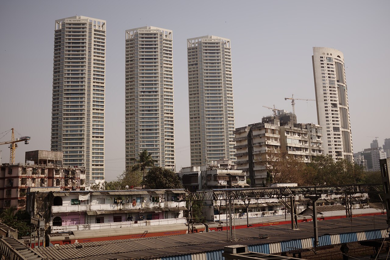 Tall residential towers rising above a railway line in Mumbai