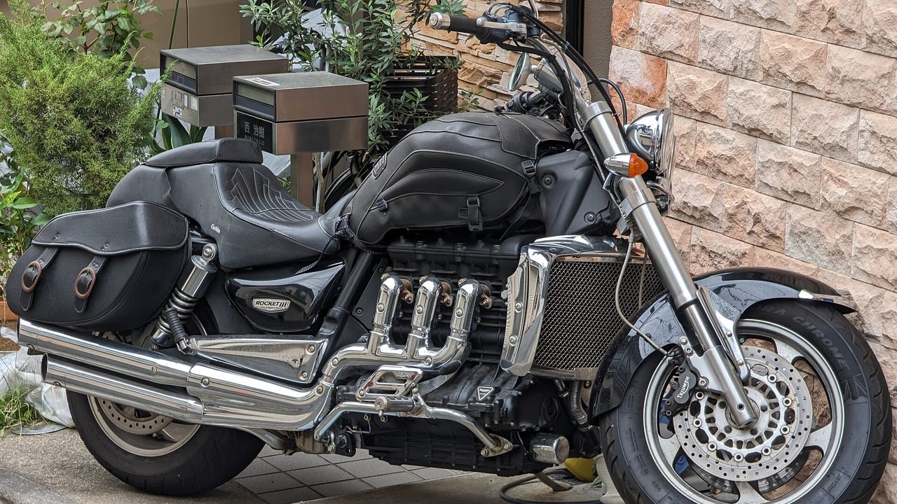 A large touring motorcycle parked beside a wall