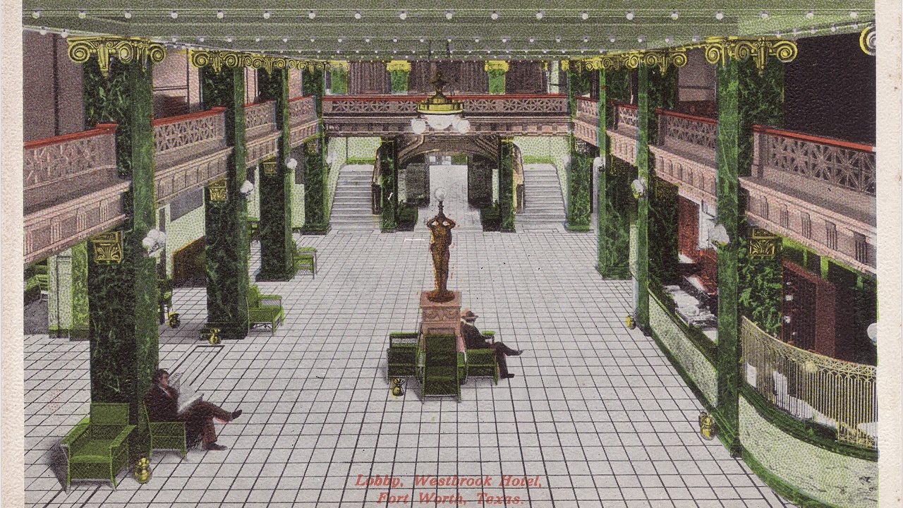 An old postcard view of a hotel lobby with columns and a statue