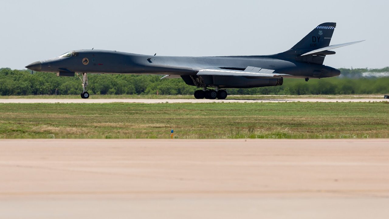 A military bomber aircraft on an airfield runway