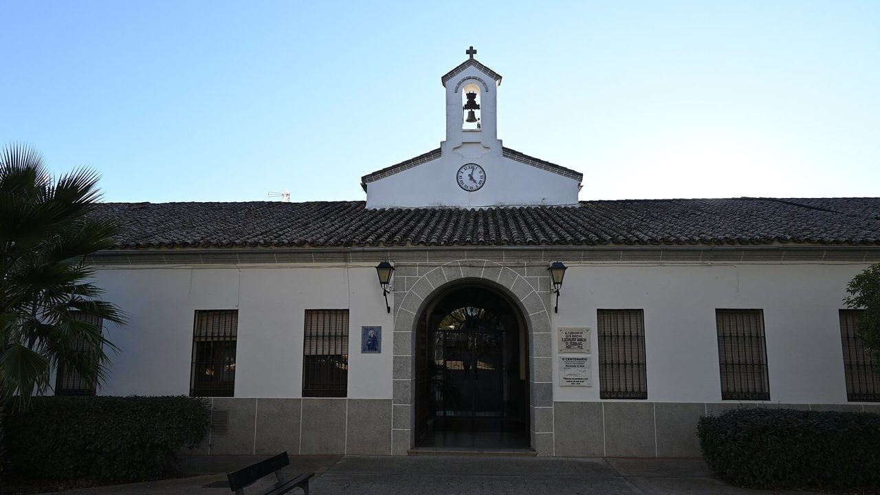 The front of a single-storey hospital building with an arched entrance