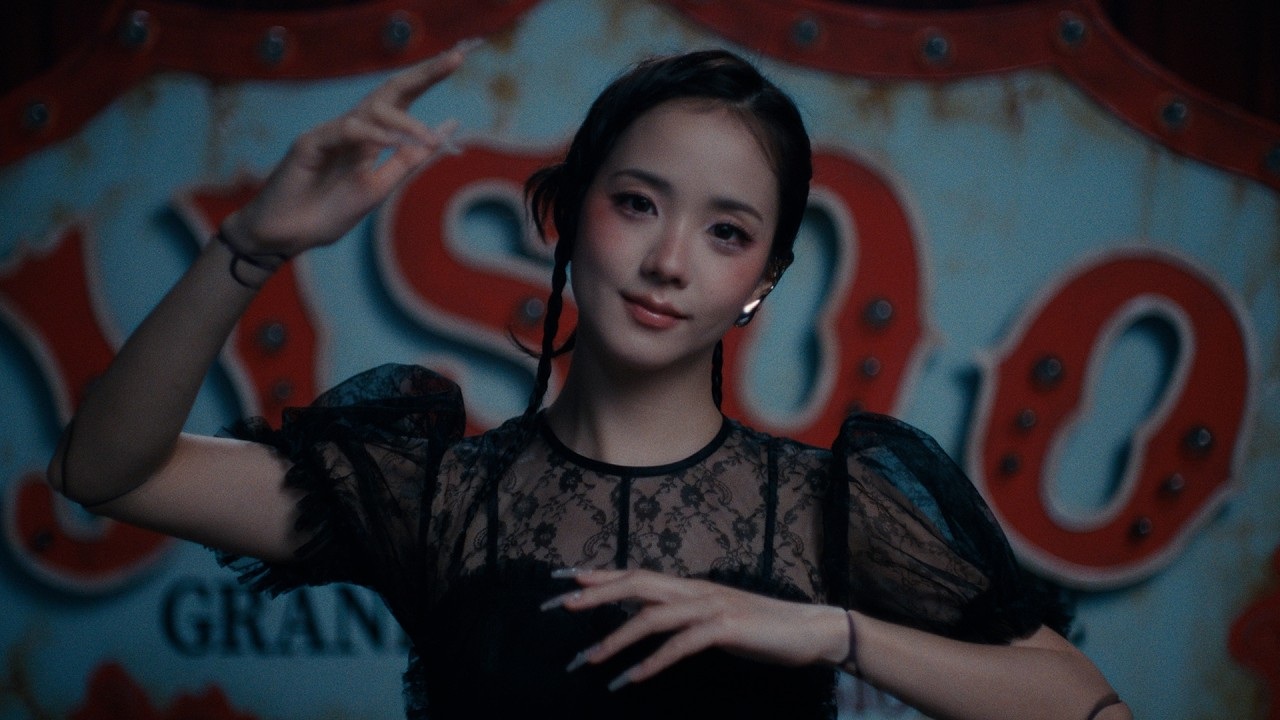 JISOO poses in front of a carnival-style backdrop in the official CLICK video thumbnail.