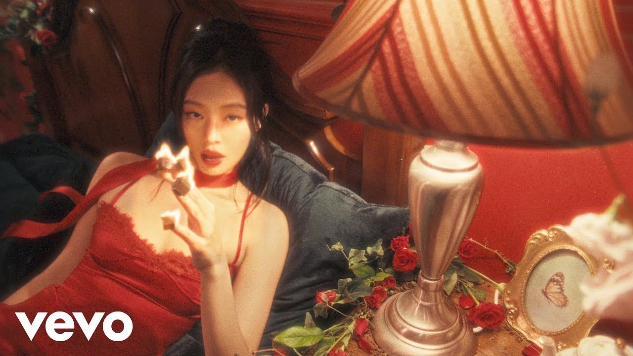 JENNIE in a red outfit in the official FALLEN ANGEL music video thumbnail.