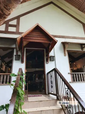 Traditional bahay na bato architecture with steep wooden roof and stone base
