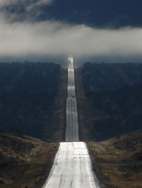 Long road going down long hill and back up another