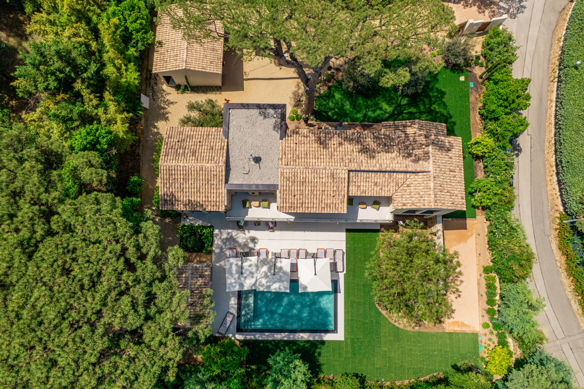  location - Sous les Pins - This luxury home offers an impressive aerial view with a pool, well-maintained garden, and modern architecture.