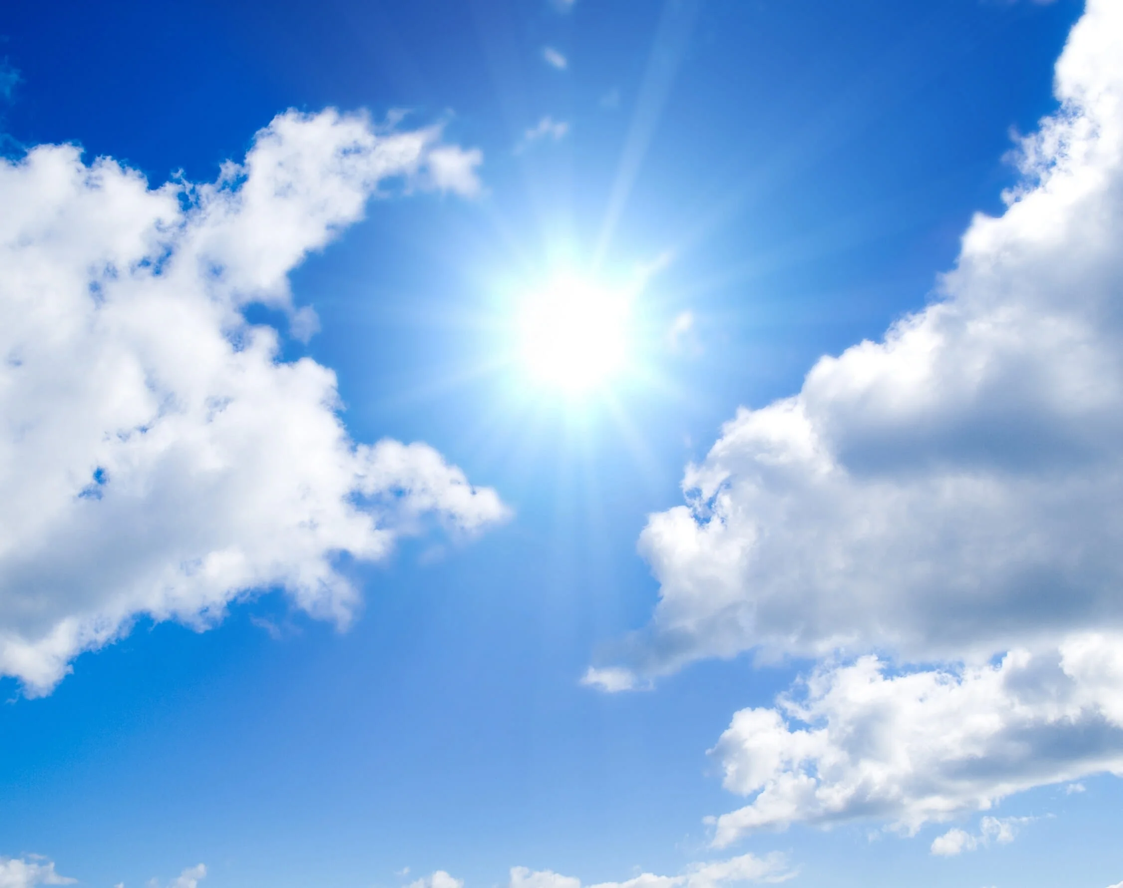 Blue sky with clouds and sun rays