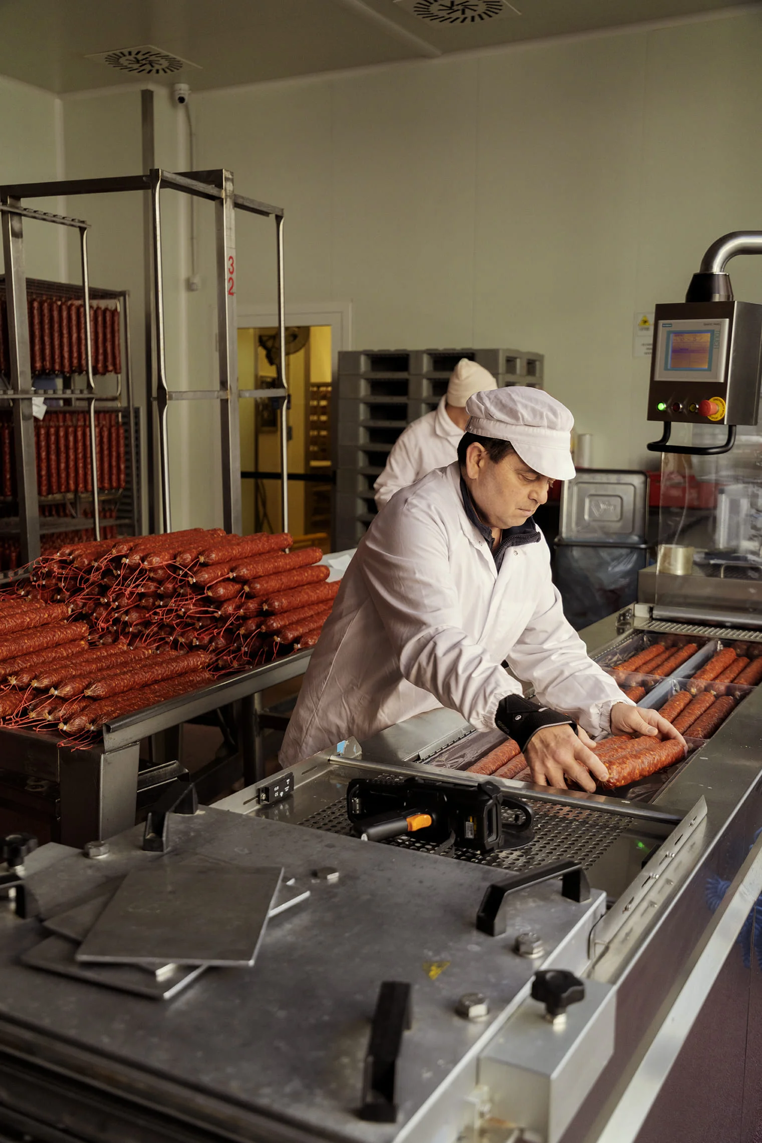 Employee packaging salami in the Bombieri production facility