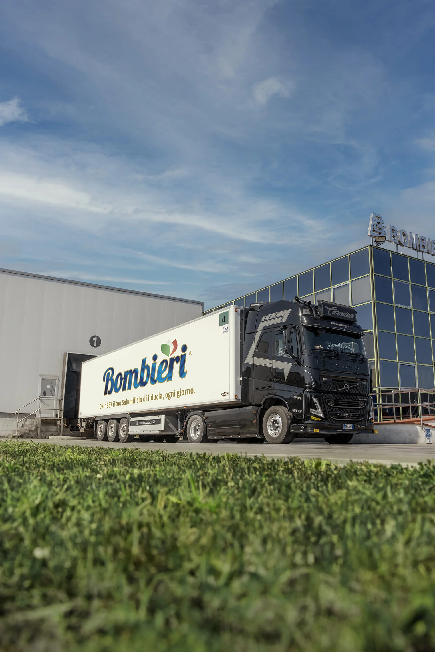 White truck with Bombieri logo on its side