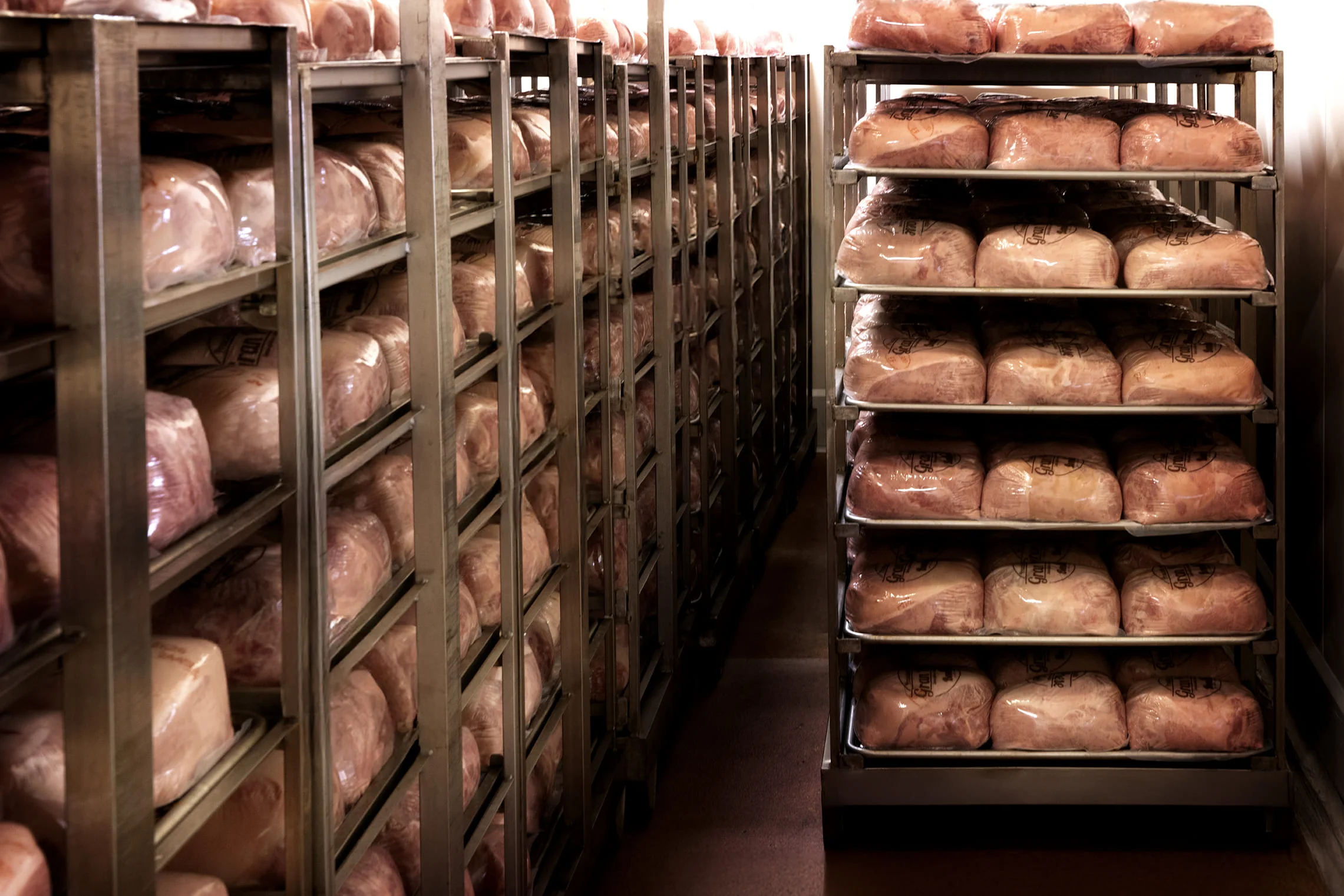 Cooked ham section, stacked and organized
