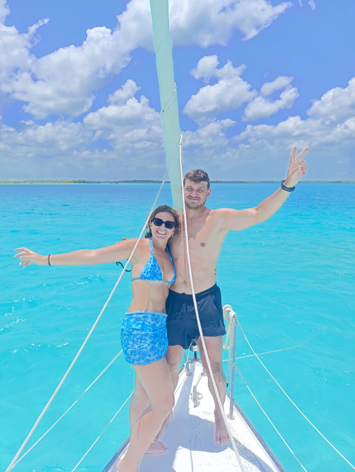 Happy couple enjoying a private sailboat in Bacalar