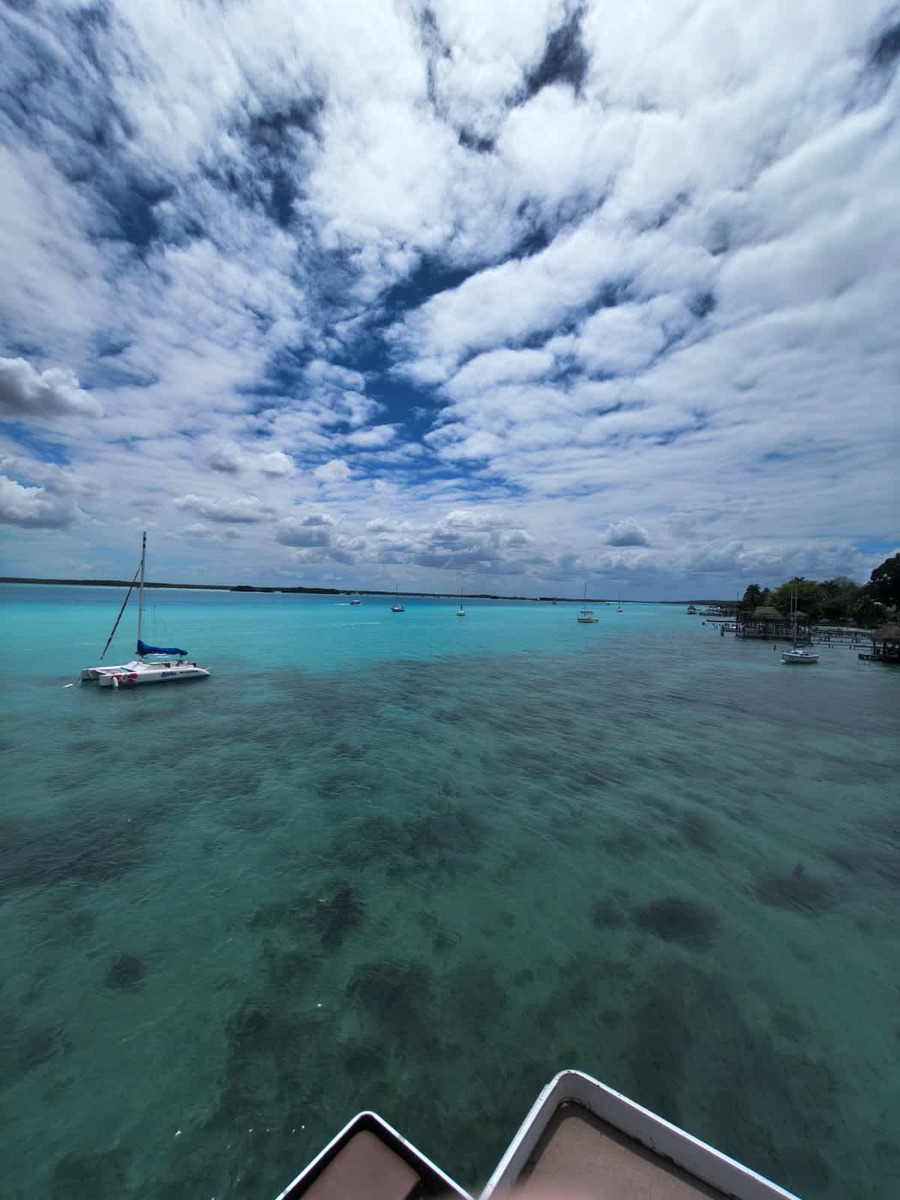 Classic sailboat anchored in the sargassum-free lagoon