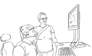 A student with a headset uses a computer, smiling up at it, while the instructor looks on.