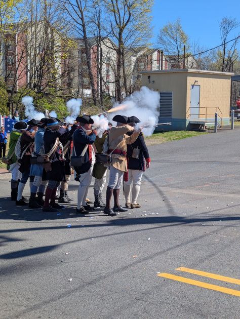 British soldiers fire a musket volley on Main Street