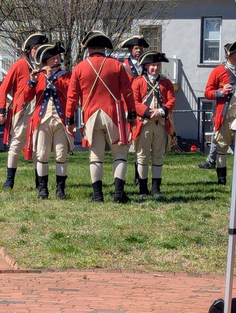 Reenactors display period regimental flags during the formal ceremony