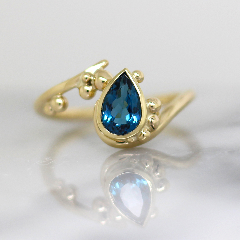 Pear shape stone and gold granulation ring