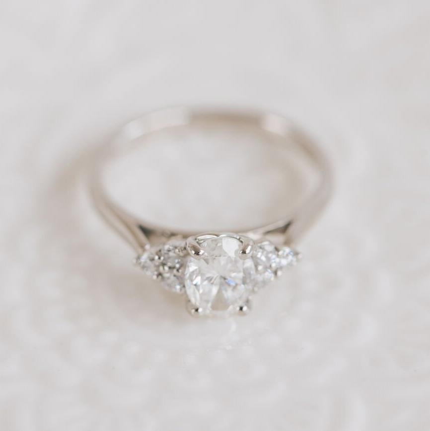 Oval Diamond engagement ring with trefoil diamonds on the shoulders