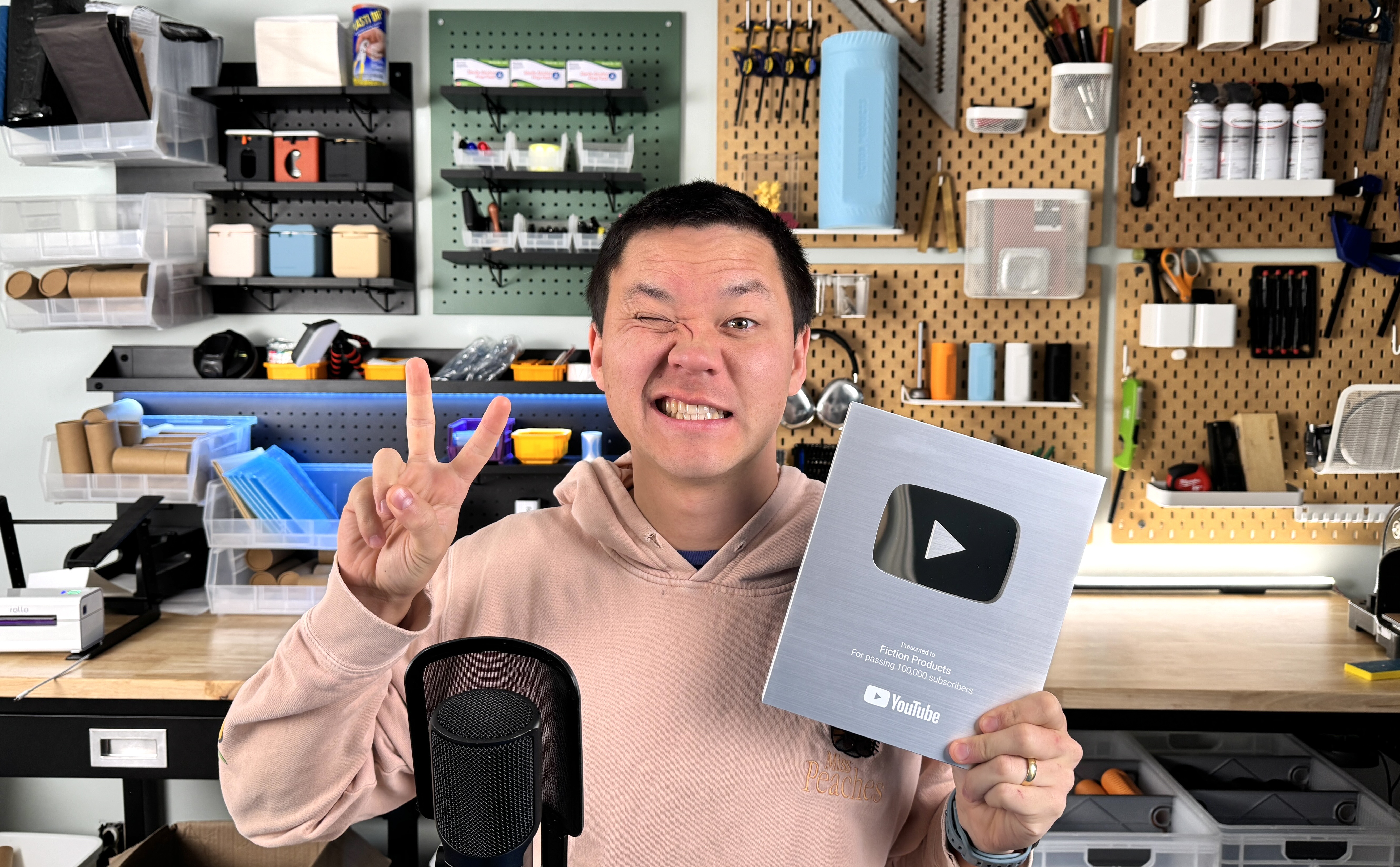 Owner of Fiction Products holding a creator award in his workshop