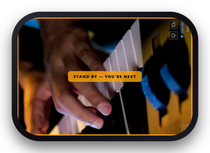 The phone held sideways showing the amber STAND BY, YOU ARE NEXT banner