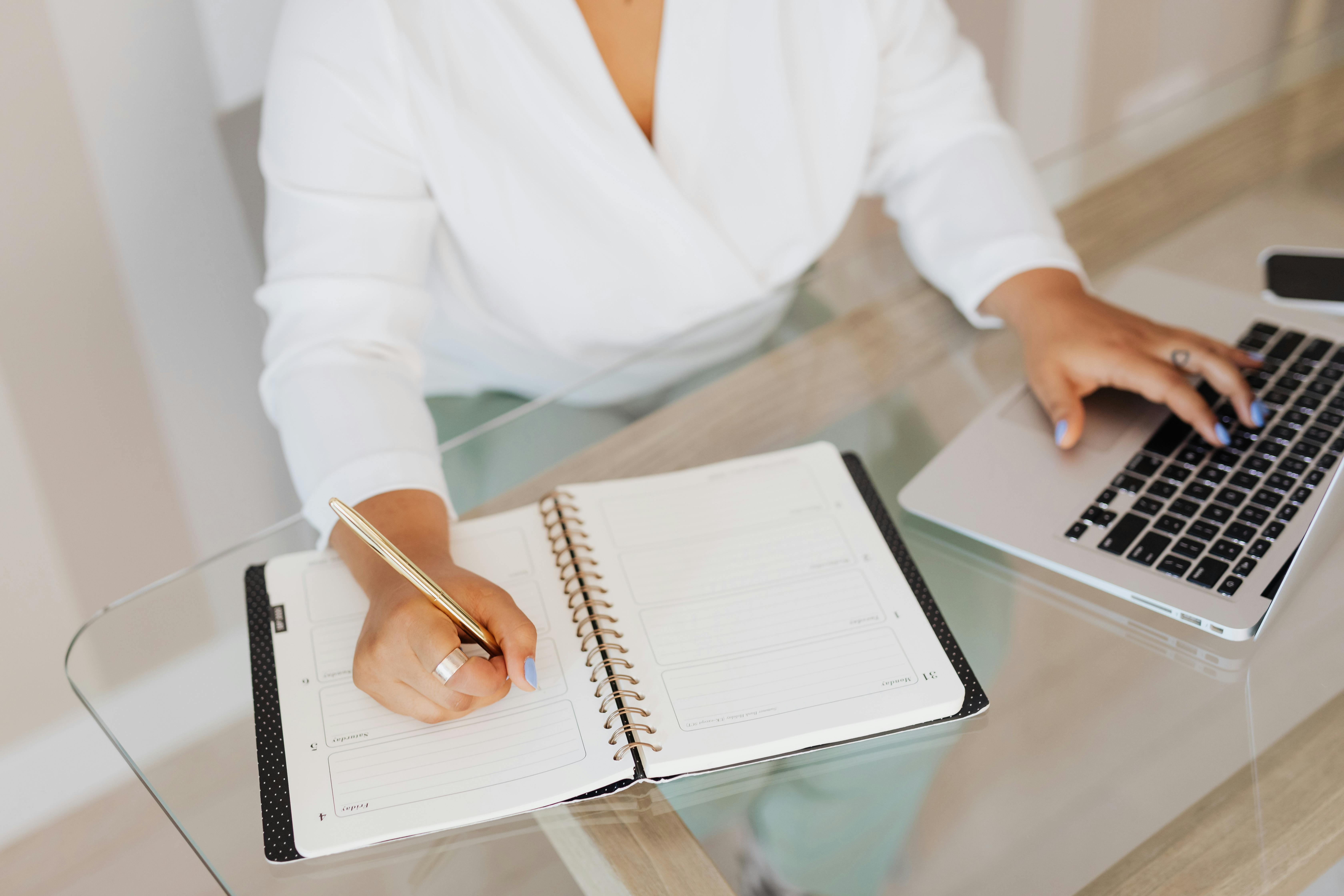 A person is taking note on a notebook without AI notetaker