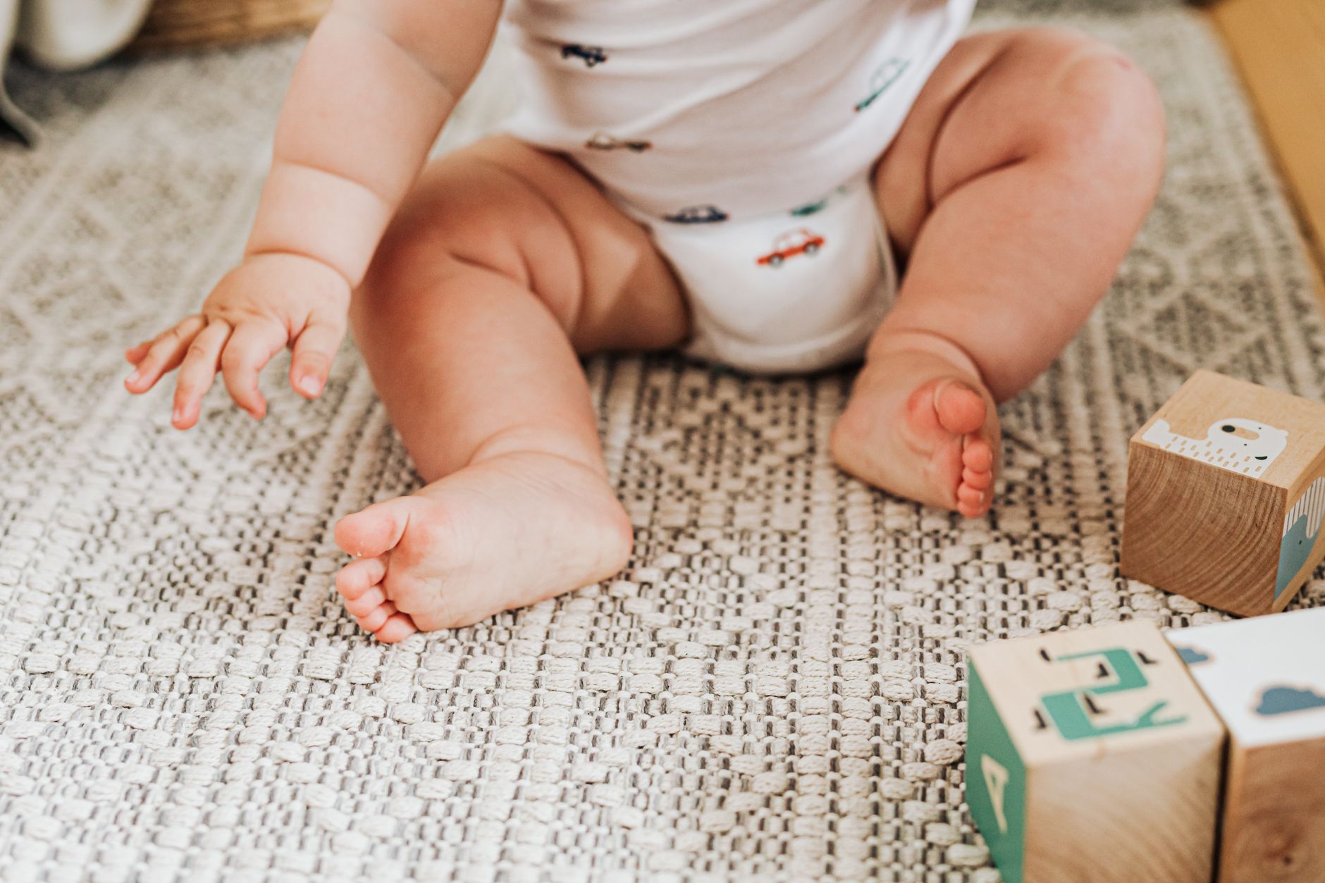 Baby holding a textured block