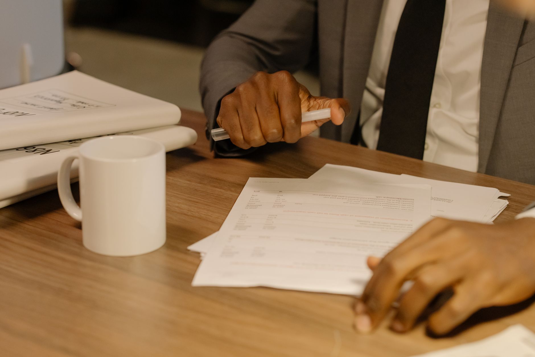 Printed ultrasound report with highlighted measurements, a calm hand holding a coffee mug, bright natural light on a wooden desk