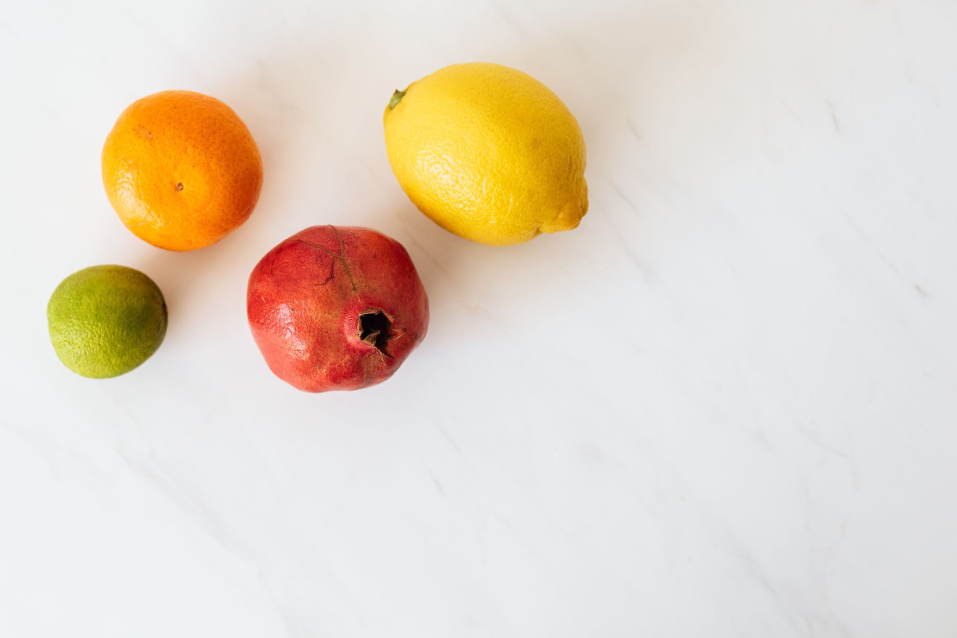A lemon next to a small baby onesie to show the size of a 14-week fetus