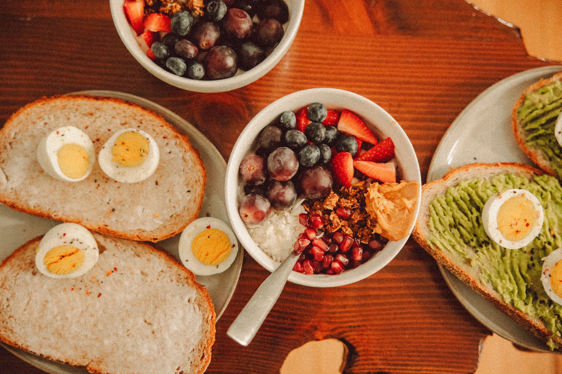 A colorful array of pregnancy-friendly foods like salmon, eggs, leafy greens, and nuts