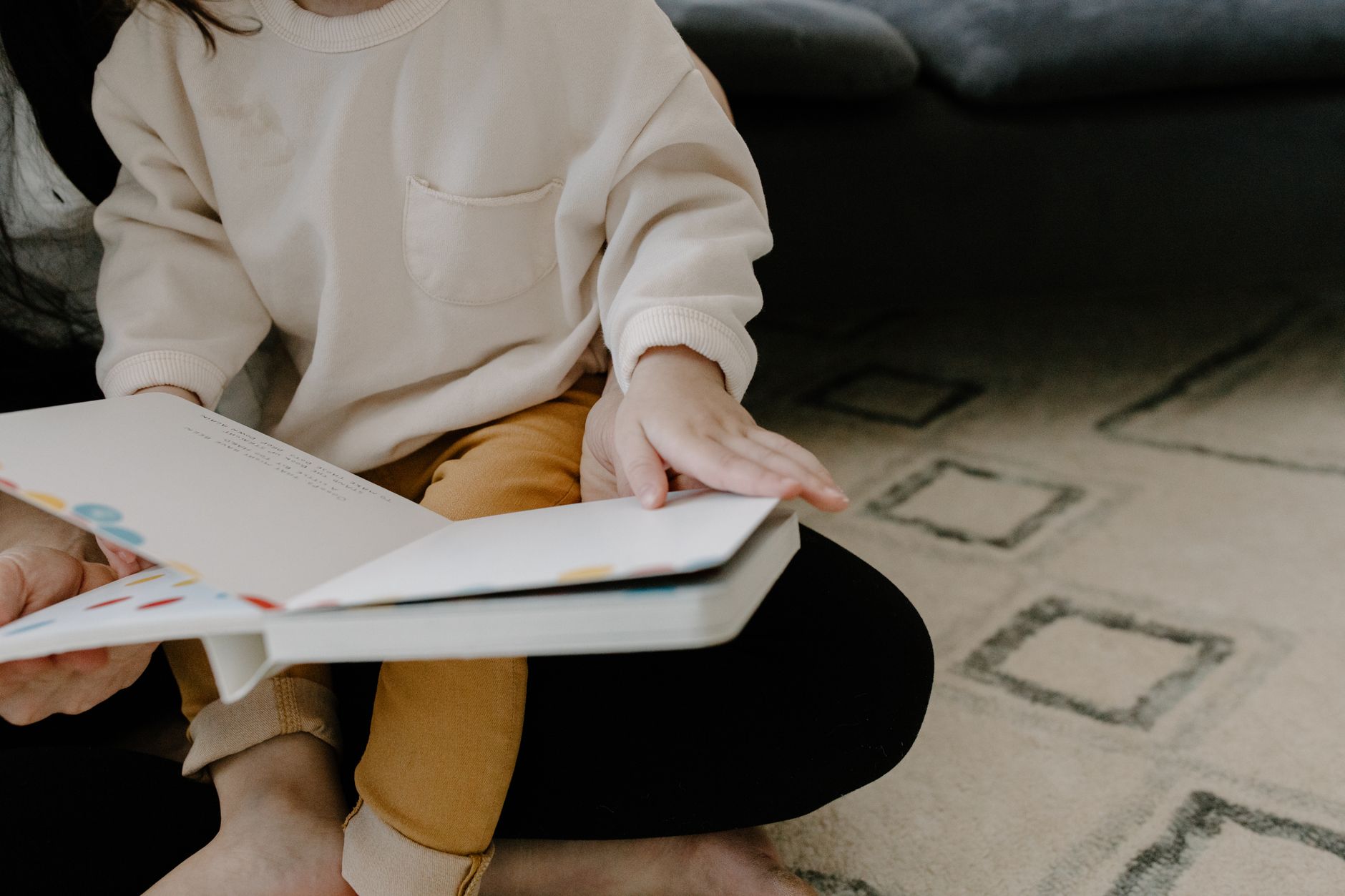 Parent reading to a 15-month-old