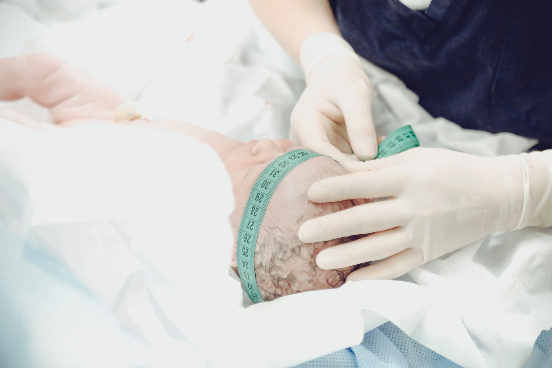 Pregnant woman at a prenatal checkup with her provider measuring her belly