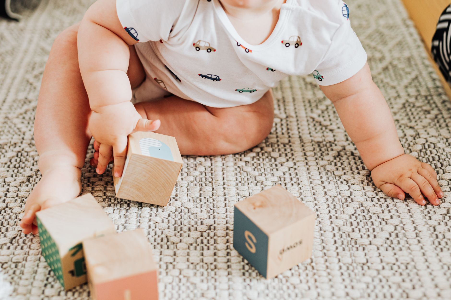 Toddler practicing fine motor skills with blocks