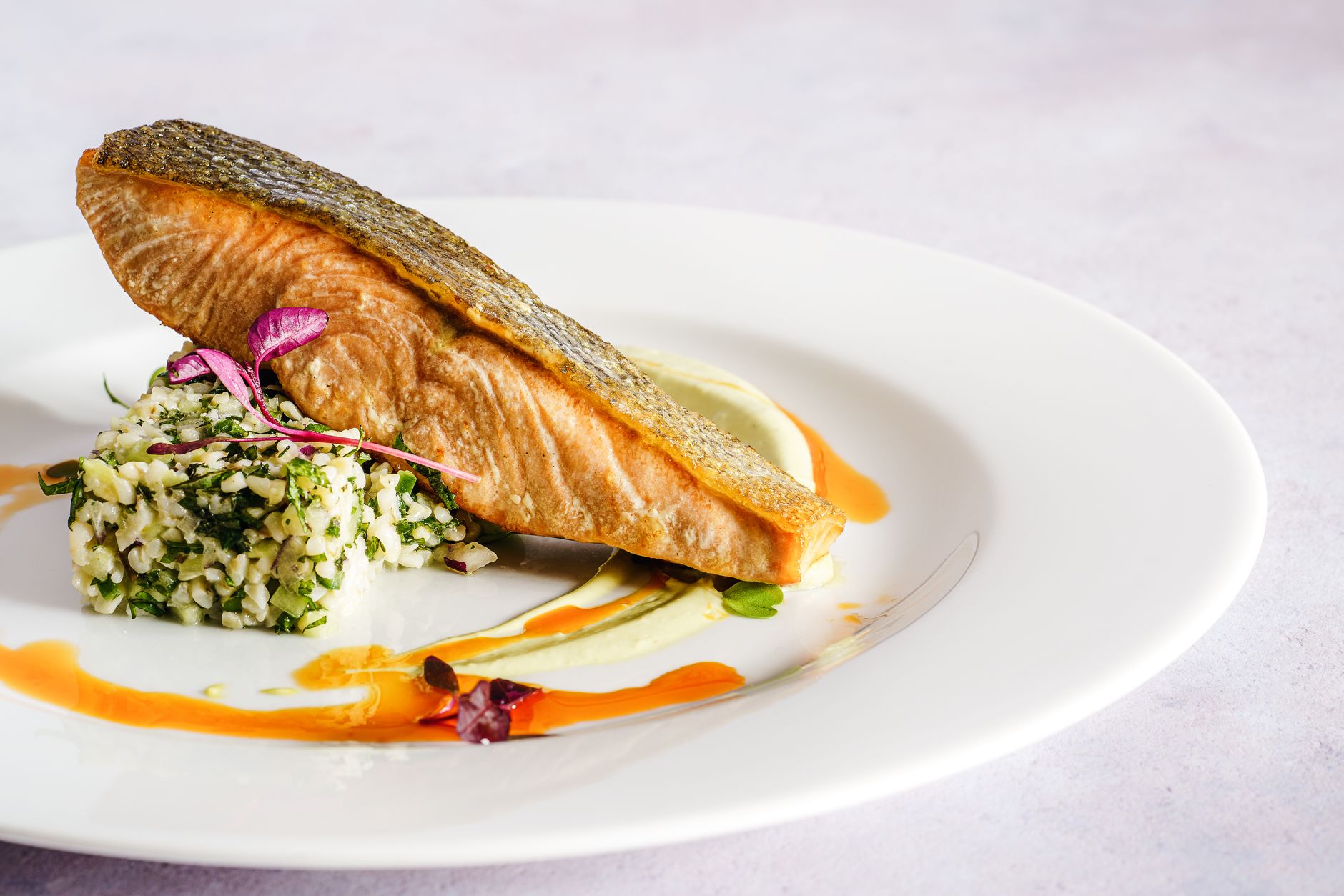 Colorful plate of nutrient-dense foods for a 17-week pregnant woman, featuring salmon, leafy greens, nuts, and fresh fruit