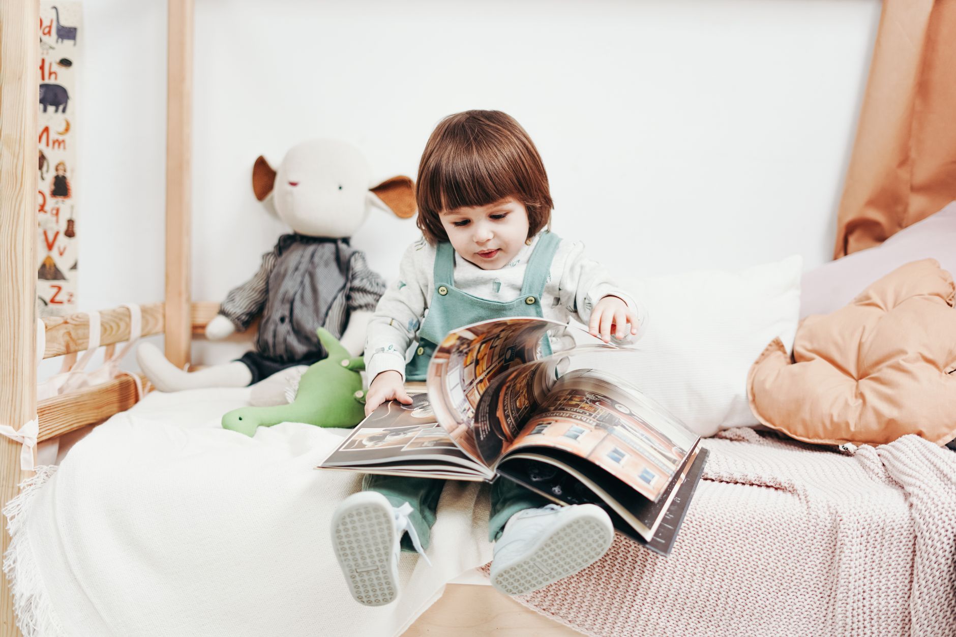 Parent reading to toddler in a cozy nook