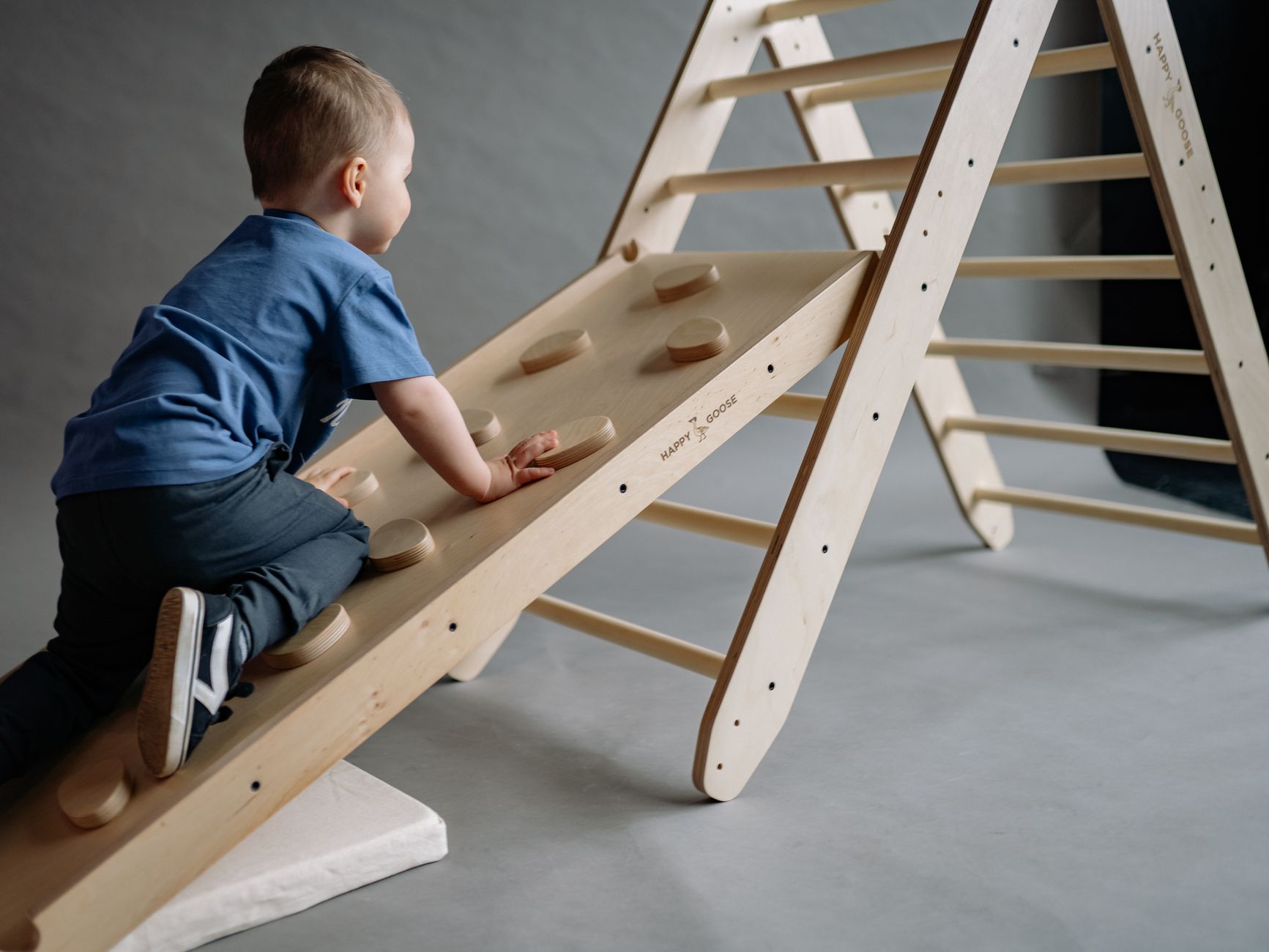 Toddler climbing steps with support