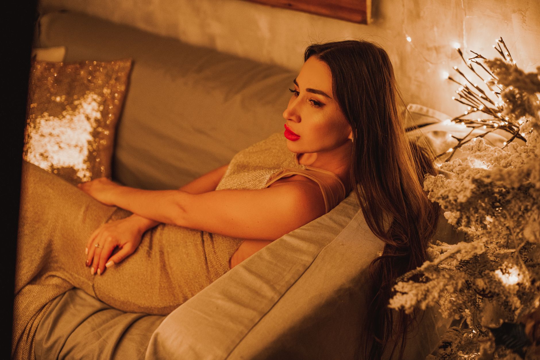 Cozy bedroom scene with a pregnant woman resting on a plush rug, a glass of water and a soft pillow nearby, natural light filtering through sheer curtains