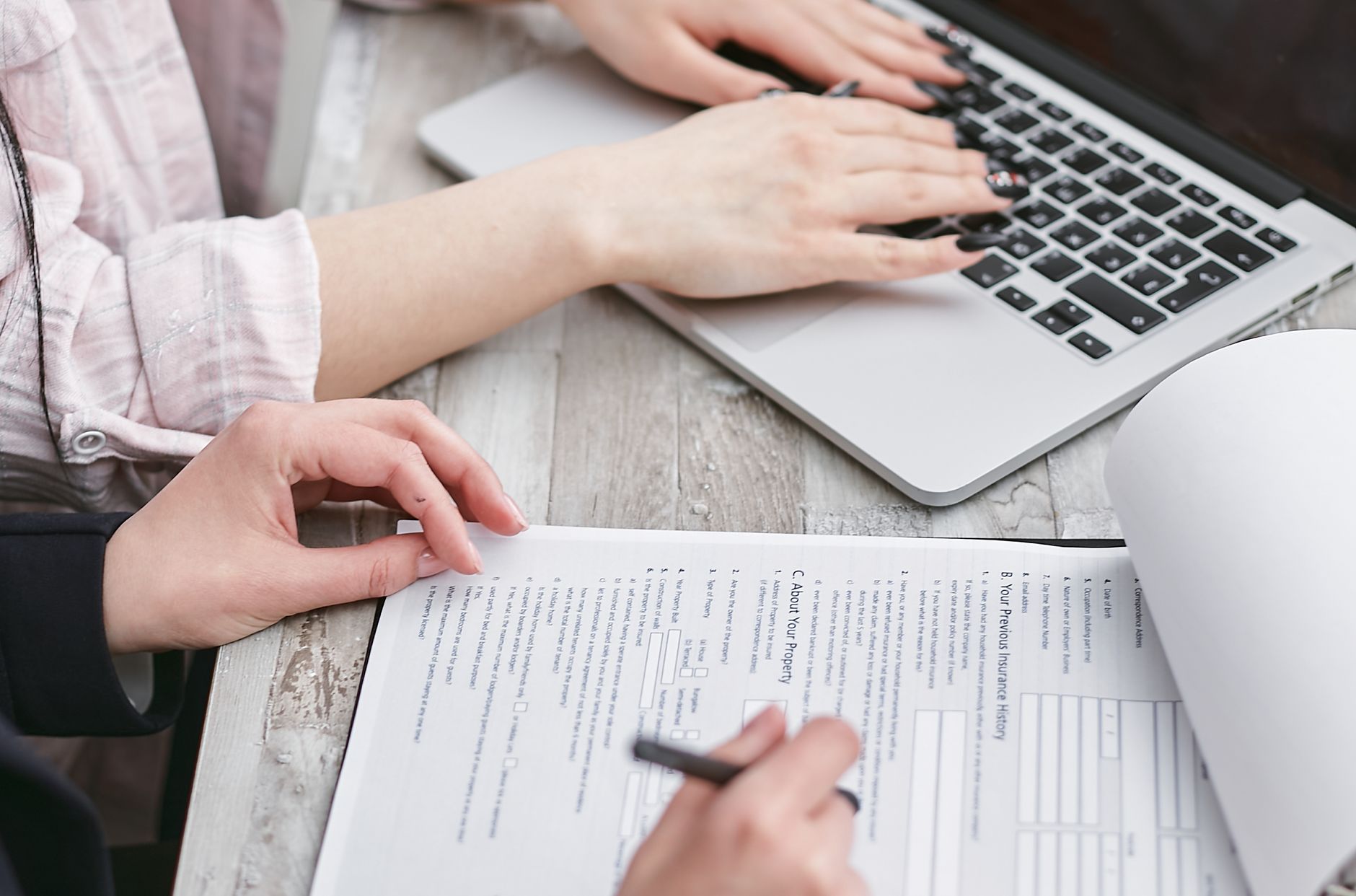 A single mother reviewing adoption loan paperwork with a co-signer