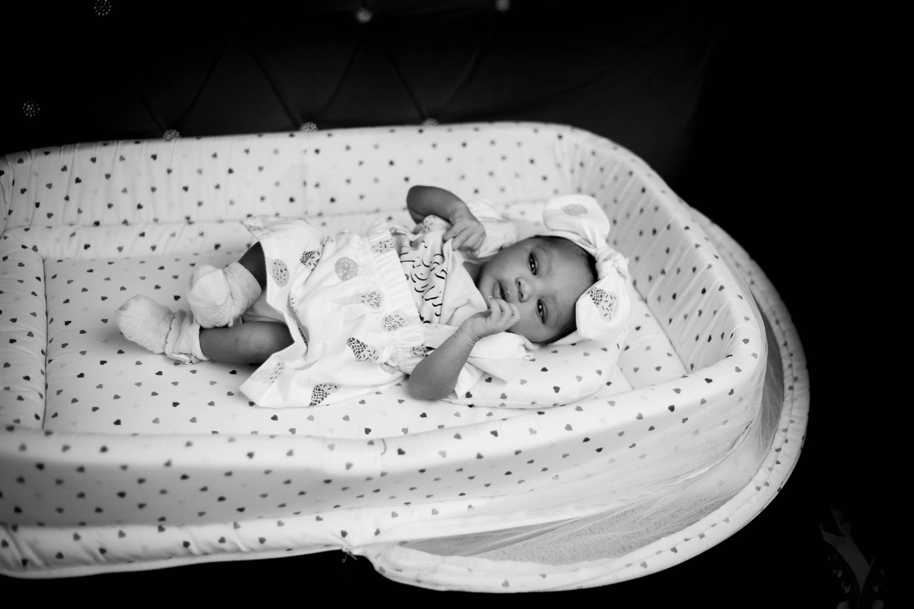 Parent reading to toddler with newborn
