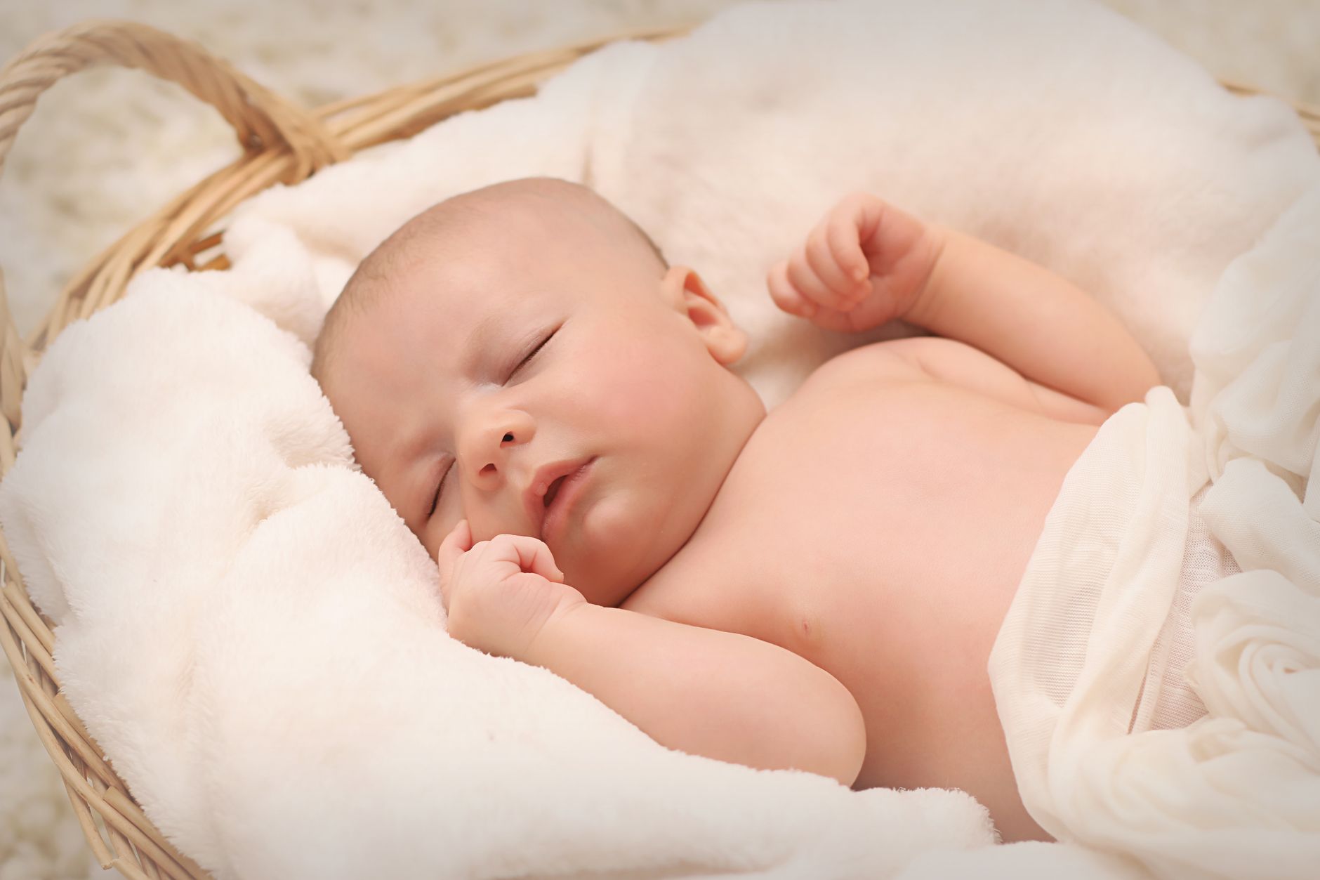 Two newborn twins wrapped in soft blankets, lying on a wooden crib, gentle morning light, illustrating the context of multiple gestation monitoring
