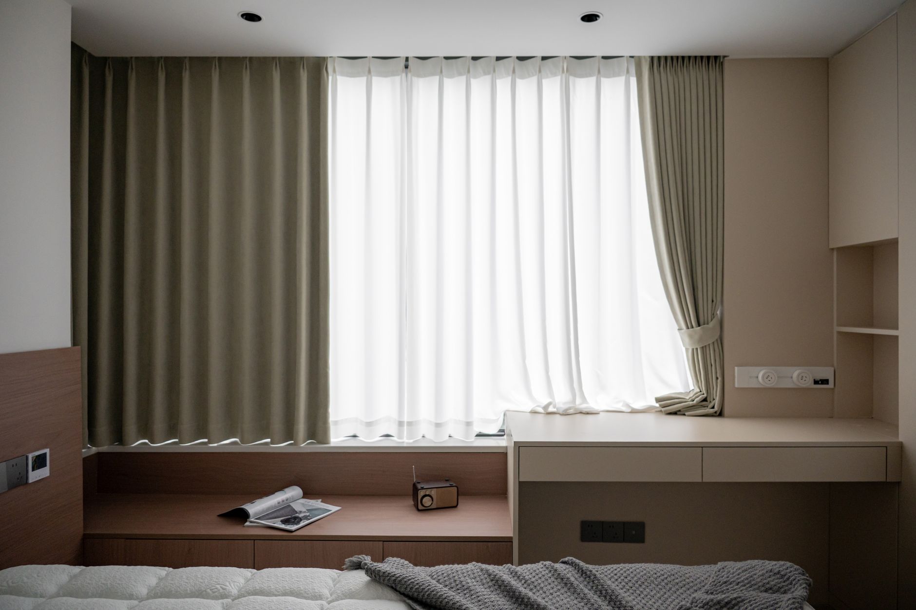 Calm bedroom with blackout curtains and a journal