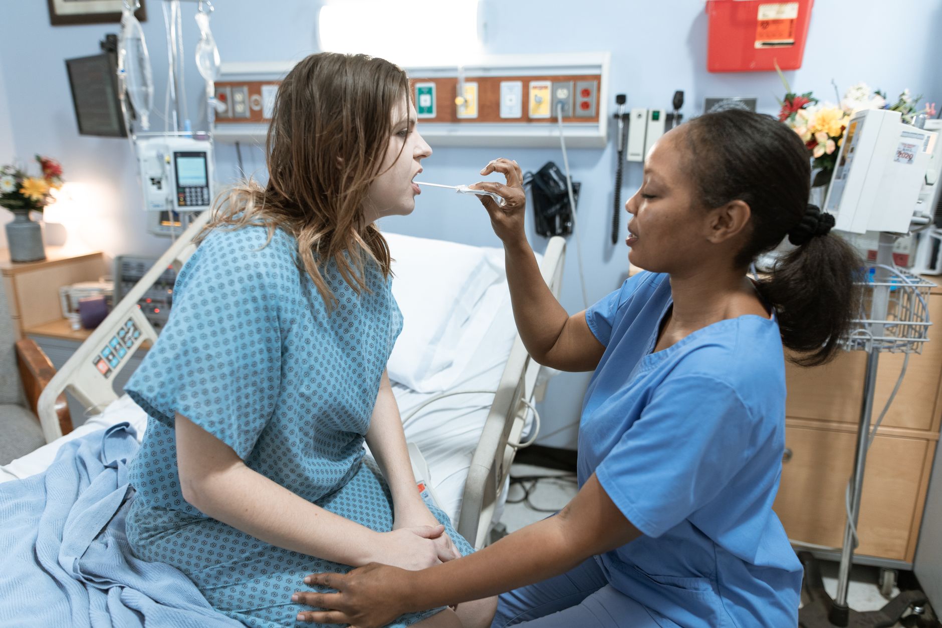 Pregnant woman resting in a hospital bed after surgery
