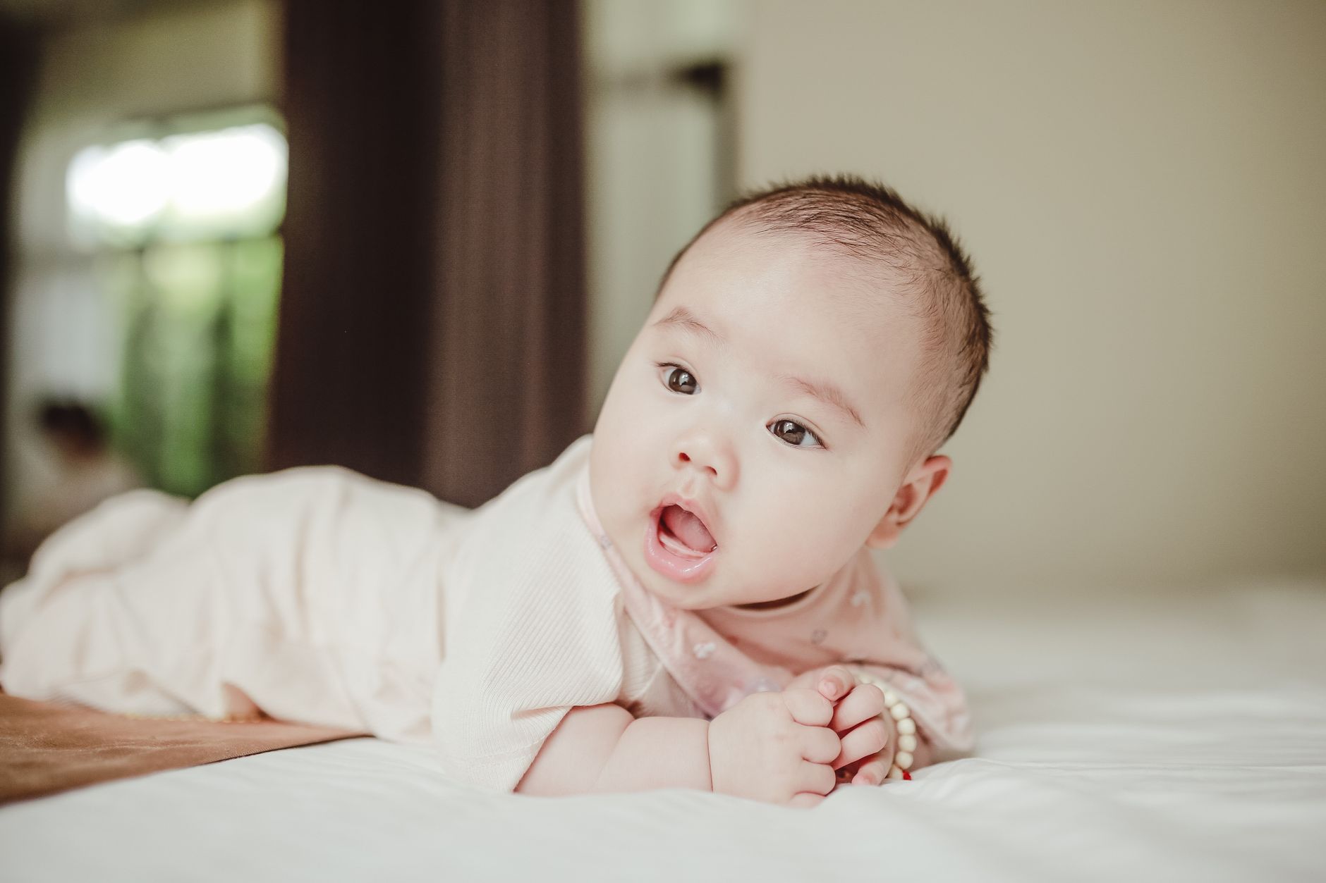 Parent performing gentle infant massage on baby's tummy
