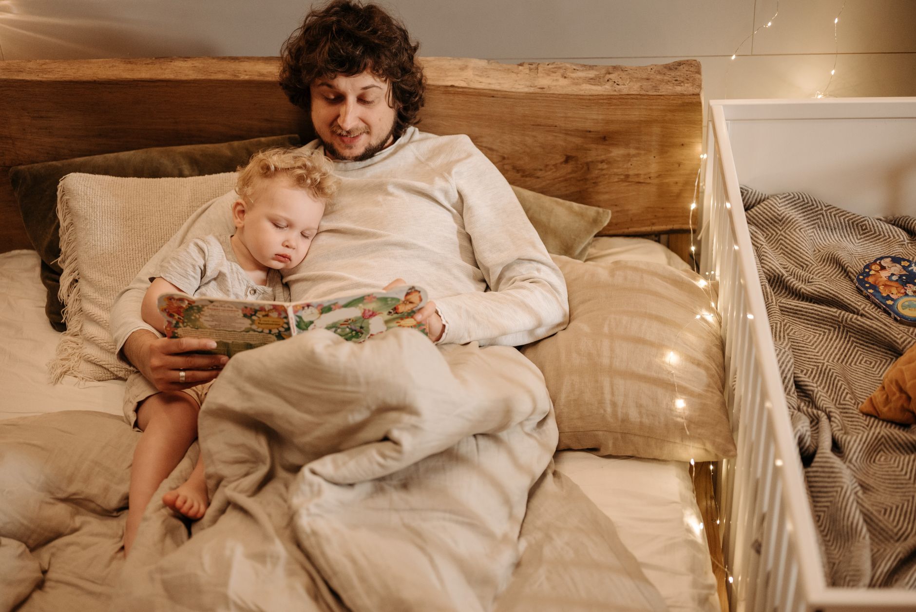 Parents reading to baby at bedtime