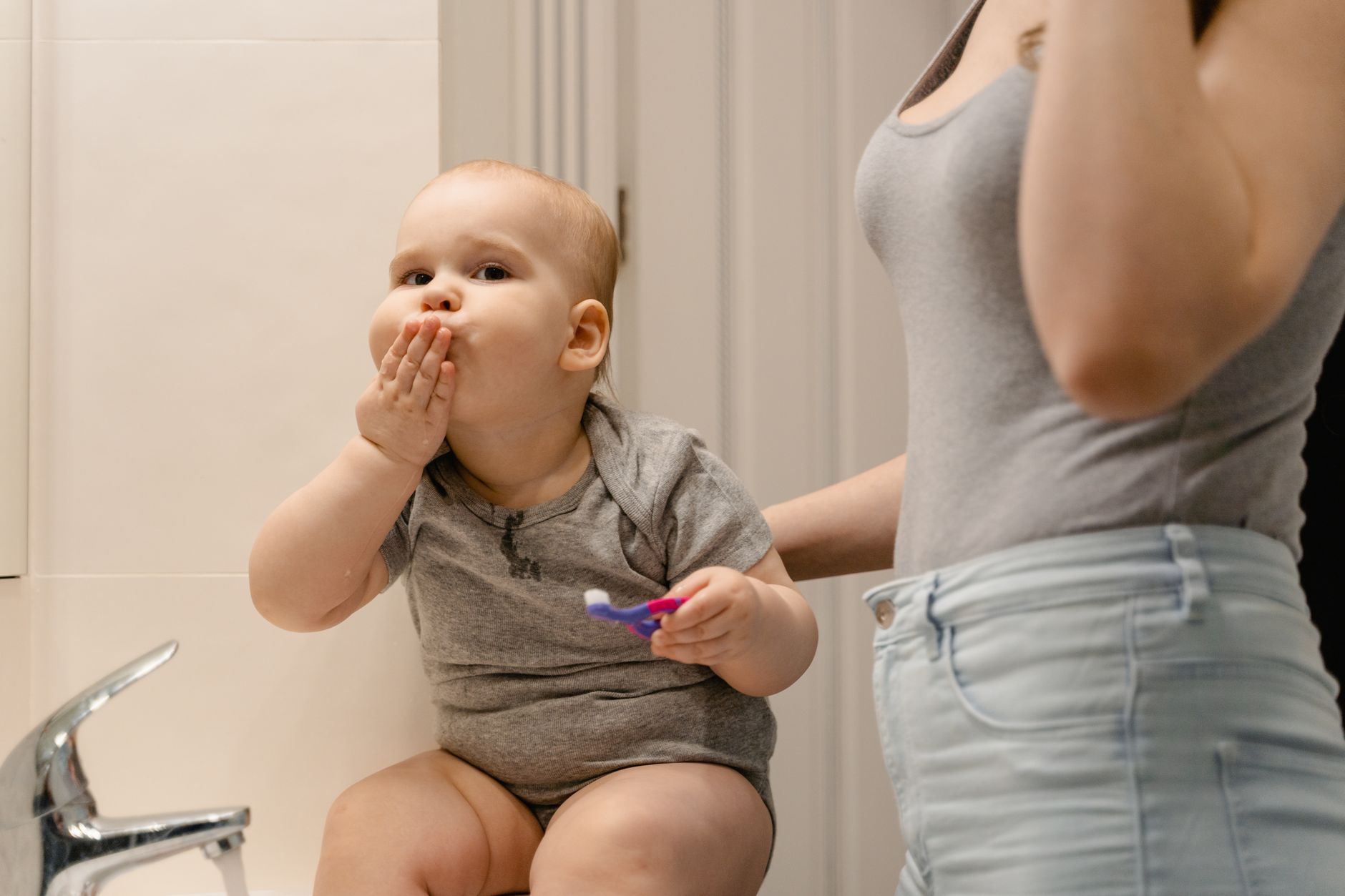 Baby reaching for an outlet with a sliding cover installed